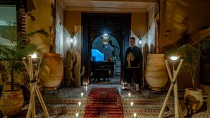 A hotel entrance with a red carpet, large vases, and candles. - Majorelle City Center Boutique Hôtel (Marrakech)
