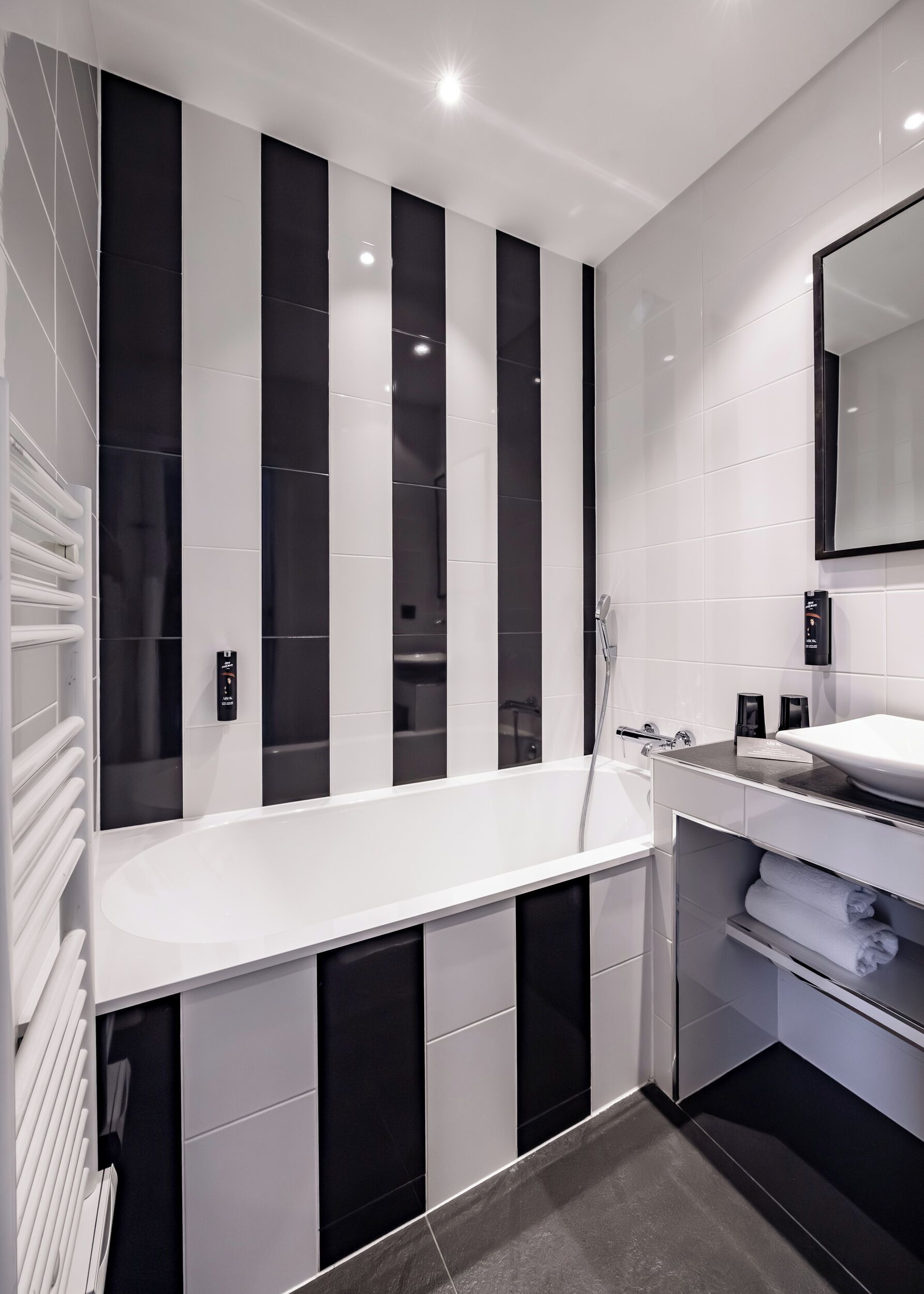 A modern bathroom with a large bathtub, a separate shower area, and a vanity with a mirror.