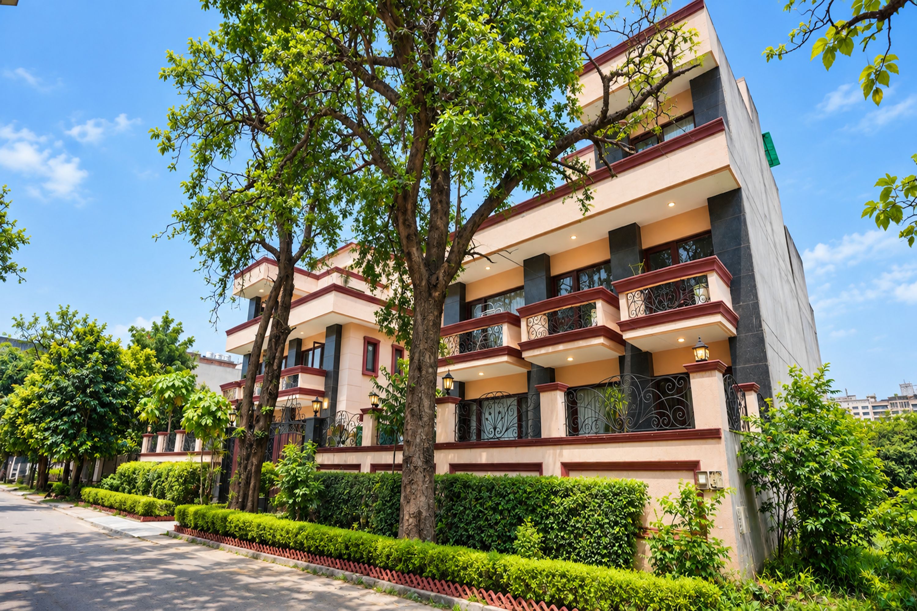 A multi-story building with balconies, surrounded by greenery and trees.