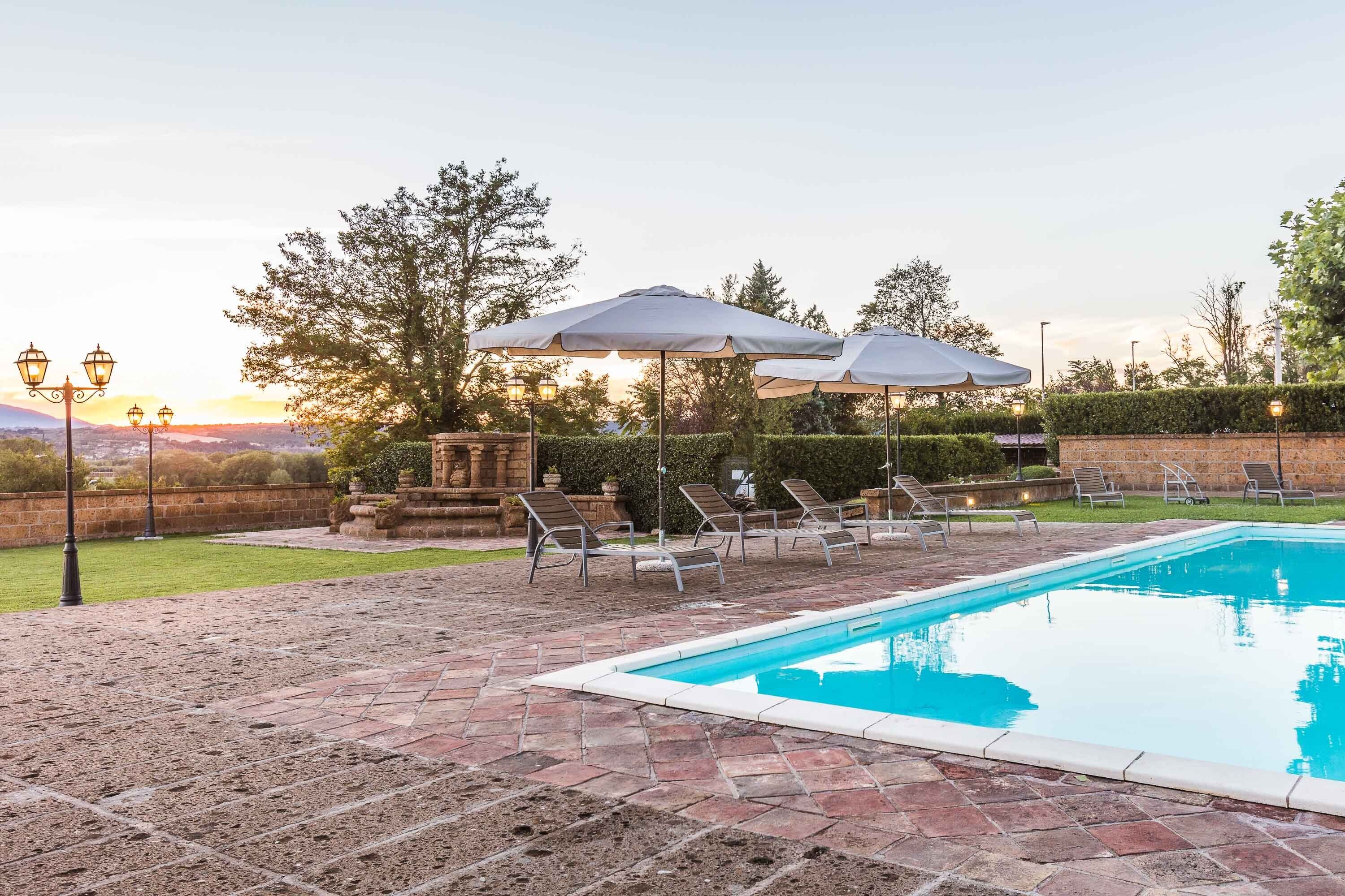 Seasonal outdoor pool, pool umbrellas, pool loungers