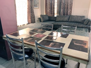 Enjoy meals in this stylish dining area with a glass-top table and comfortable seating for four.