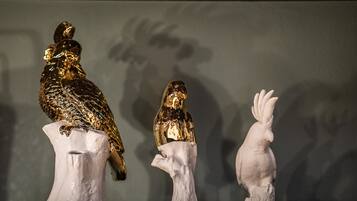 Three bird sculptures on pedestals.