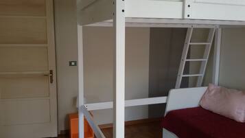 Un lit superposé avec une échelle, une porte et une petite boîte de rangement orange.