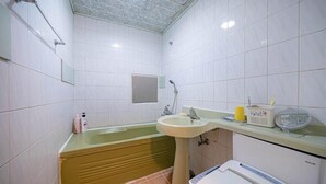 A bathroom with a bathtub, sink, and toilet.