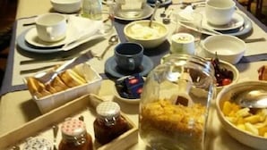 A dining table set with various dishes, utensils, and condiments. - Agriturismo Solidor (Pitigliano)
