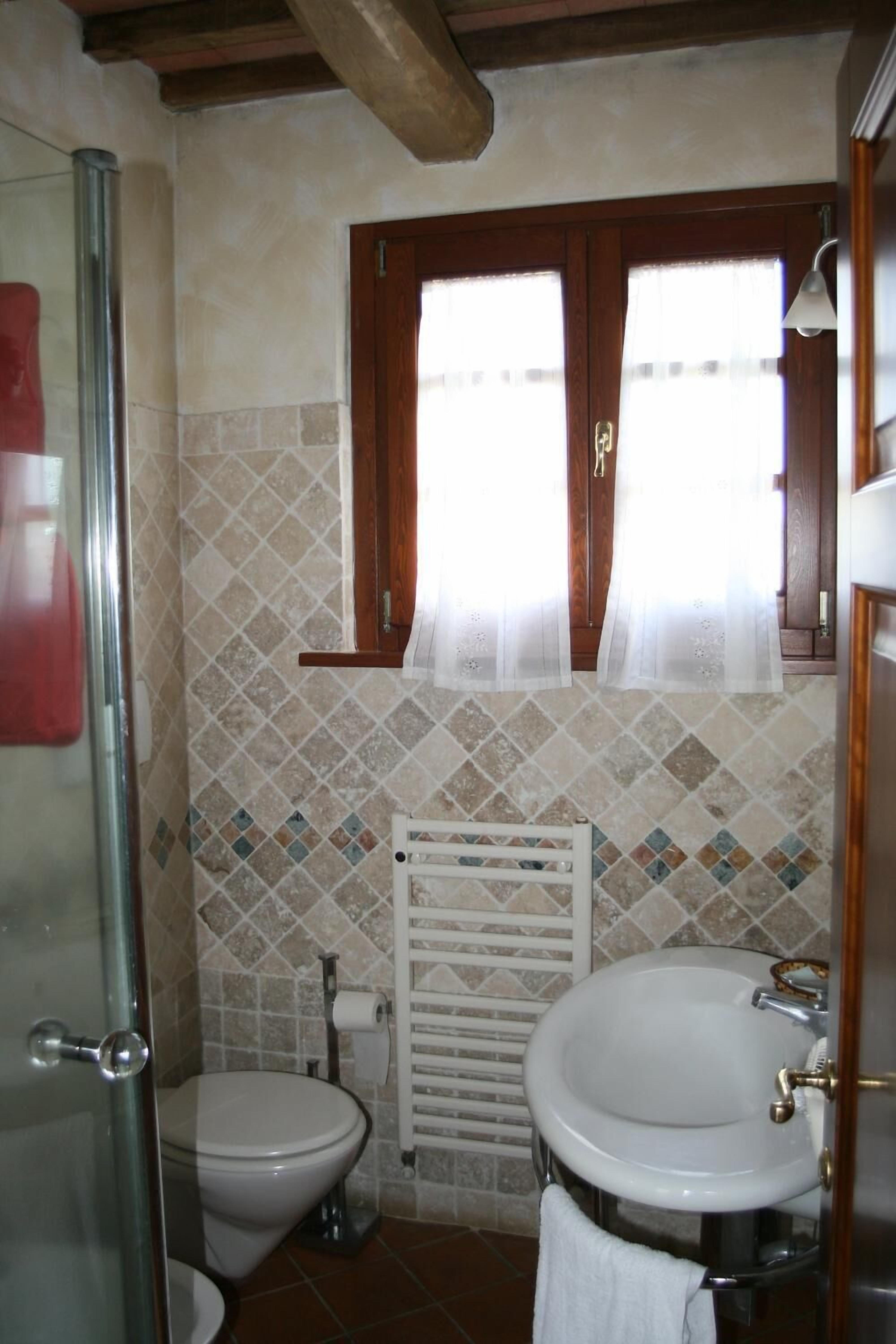 Ein Badezimmer mit Toilette, Waschbecken und Dusche.