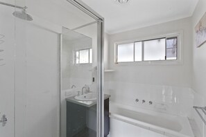 Bathtub, hair dryer, towels, soap