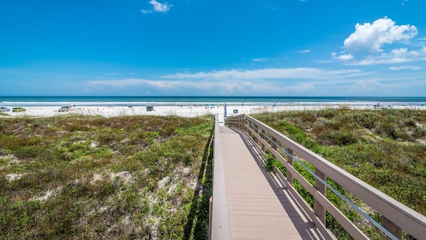 A boardwalk leading to a beach with dunes and a clear blue sky. - FREE FUN during your stay in this Gold-rated condo with beautiful ocean view and easy access to the pool and beach! (Saint Augustine)