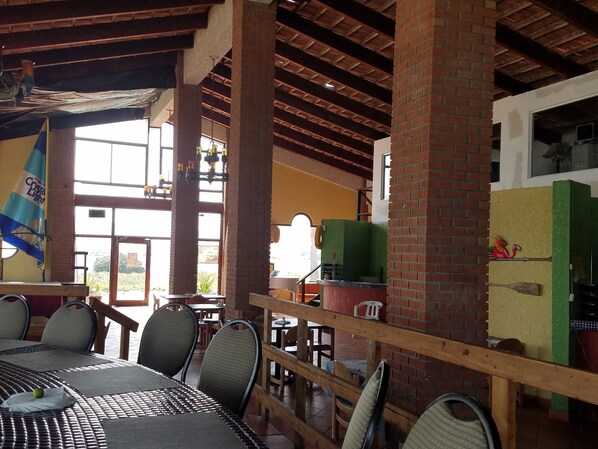 A restaurant with a rustic interior, featuring exposed brick walls, wooden beams, and a mix of indoor and outdoor seating. - Sleeps 15: Beautiful 3,300 sqft, 2 Story Beach Home w/NEW 9 ppl /72 jet HOT TUB! (Pob. E. Cantu, Punta Bunda, Ensenada)