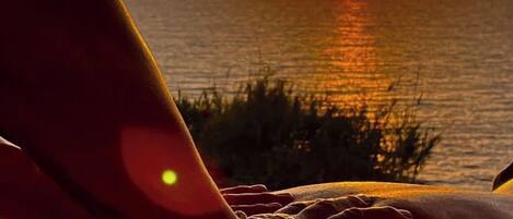 A sunset view with a person receiving a massage.