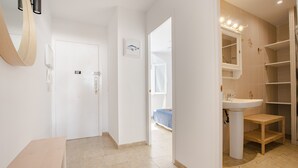 Une salle de bain moderne avec un lavabo, un miroir et des étagères.