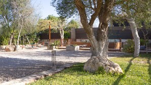A landscaped outdoor area with trees, a gravel path, and a playground.
