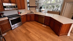 A spacious kitchen with wooden cabinets, stainless steel appliances, and a large island. - Spacious Sea Pines home - professionally decorated - Private Pool/Hot Tub (Hilton Head Island)