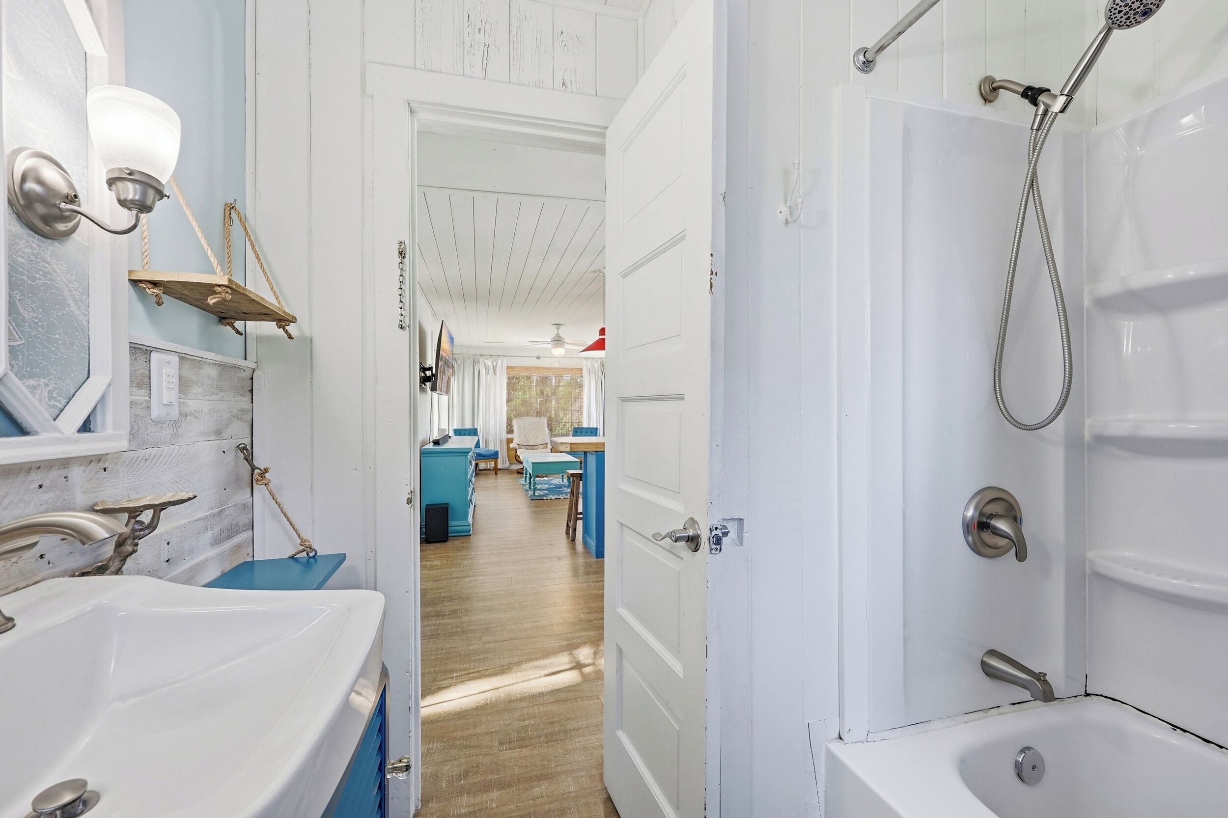 A bathroom with a bathtub, shower, and sink.