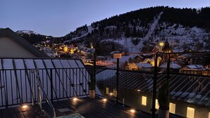 A rooftop pool with a view of a snowy mountain town at dusk. - Ski In/Out and on Main Street! It Doesn't Get Any Better! (Park City)