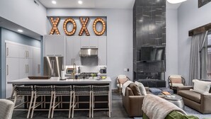 A modern kitchen with a central island, bar stools, and a dining table. - Ski In/Out and on Main Street! It Doesn't Get Any Better! (Park City)