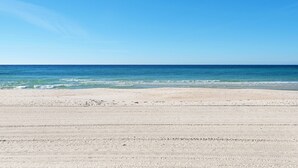 A beach with a clear sky and calm sea.