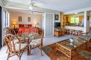 Clean and cool open floor plan with tile flooring in the living room  and kitchen area