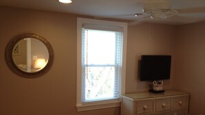 A bedroom with a bed, dresser, television, and a window with blinds. - 🥇PRIVATE COASTAL COTTAGE - Single Private - Central Air, Xfinity Cable, WIFI🏖 (Wildwood Crest)