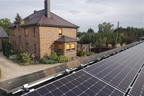 A brick house with solar panels on the roof.