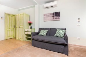 Deluxe Studio, 1 Queen Bed with Sofa bed | Living area | Flat-screen TV