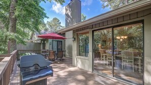 A covered deck with a grill, outdoor furniture, and a large sliding glass door leading to an indoor dining area. - 4 Hollyberry - Dog Friendly.  Great Community Amenities (Hilton Head Island)