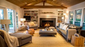 A cozy living room with a fireplace, comfortable seating, and a bookshelf. - Spa-like Estate, Wine Country Getaway, above the Sonoma Square, Amazing Views (Sonoma)