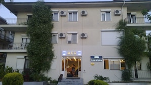 A building with multiple air conditioning units, a sign reading "MER", and a staircase leading to the entrance. - Mer Pansiyon (Fethiye)