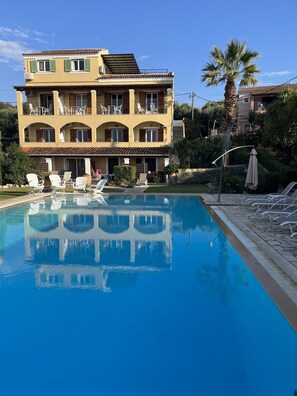 A hotel with a pool, outdoor seating, and a garden. - Villa Eleni Corfu: Seaview, Pool, Sleeps 10-20, Near Beach & Village! 🌊🏡 (Acharavi)