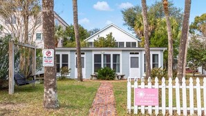 A house with a 'No Parking' sign, a swing set, and a 'Tybee Vacation Rentals' sign. - Captains Quarters A | 1.5 Blocks to Beach and Pier (Tybee Island)