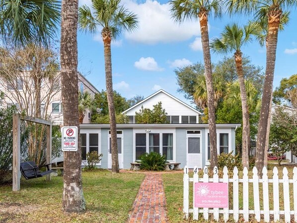 Une maison avec un panneau indiquant « Stationnement interdit », une balançoire et un panneau indiquant « Tybee Vacation Rentals ».