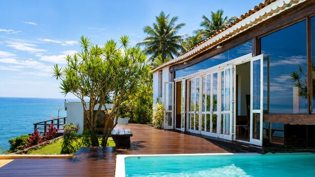 A modern resort with a swimming pool, wooden deck, and ocean view. -  CLIFFSIDE - Boutique Hotel & Spa (Rio de Janeiro)
