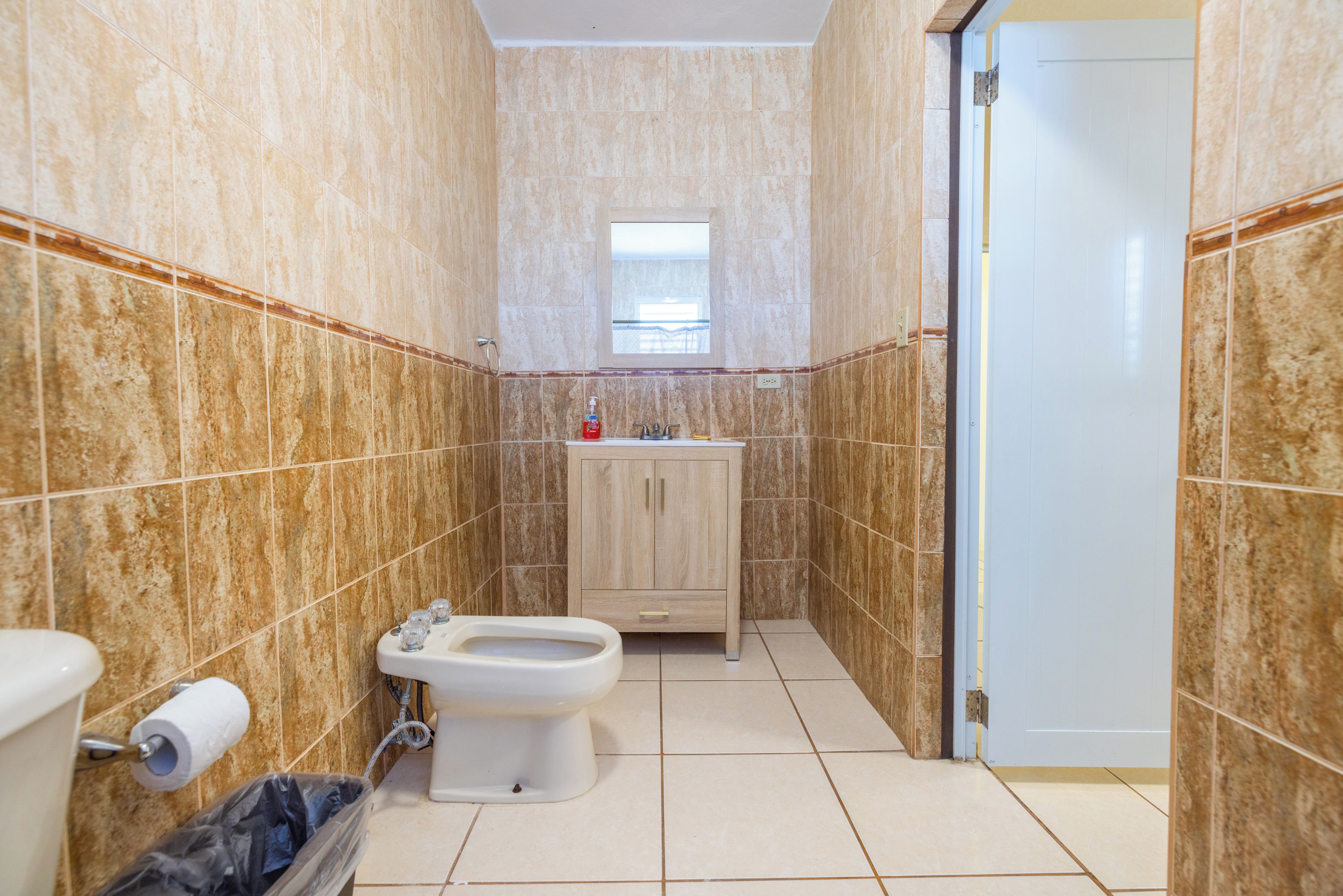 A bathroom with a toilet, bidet, and sink.