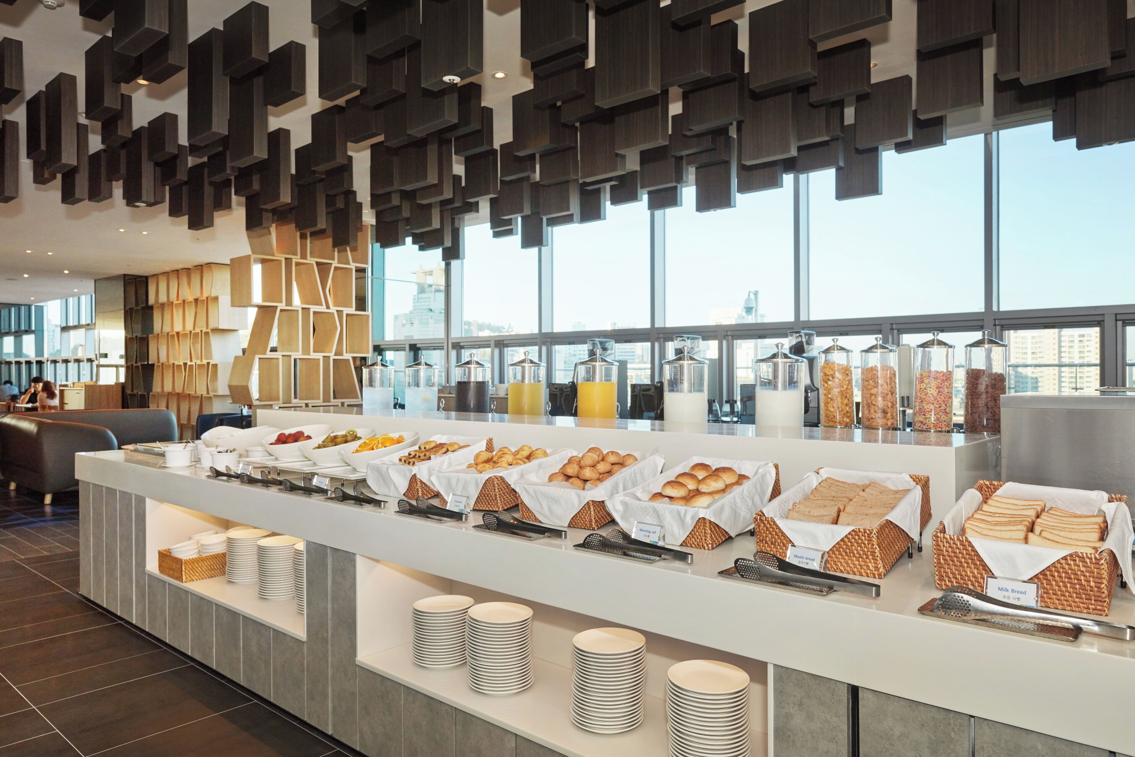 A breakfast buffet with various food items and utensils.