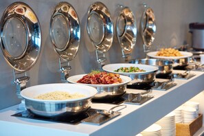 A buffet setup with various dishes and utensils. - Holiday Inn Express Seoul Hongdae by IHG (Seoul)
