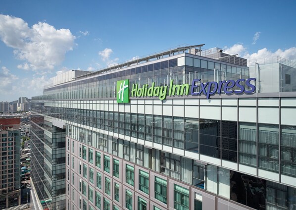 A Holiday Inn Express building with a modern glass facade and a prominent sign. - Holiday Inn Express Seoul Hongdae by IHG (Seoul)