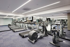 A modern gym with various cardio machines, mirrors, and a checkered floor. - Holiday Inn Express Seoul Hongdae by IHG (Seoul)