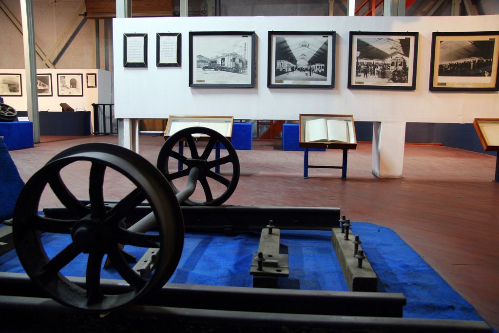 A museum exhibit with historical photographs and mechanical models.