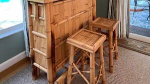 A room with a bamboo bar area, two stools, a ladder, and a view of a pool. - Tropical Getaway!!!! (Jensen Beach)