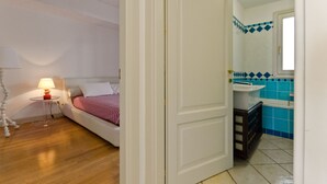 A bedroom with a bed, bedside table, and lamp. - Beautiful View, Pool ,two steps from city center !! (Taormina)
