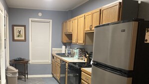 A kitchen with wooden cabinets, a stainless steel refrigerator, a stove, and a sink. - Pegasus Lair Upper Floor Apt.NoPetFee, NoChores.Short Walk to Satellite Venue! (Memphis)