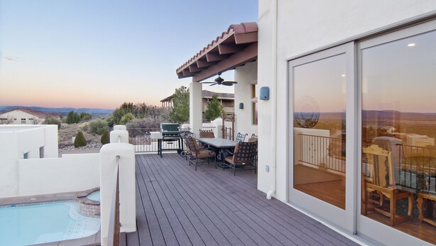 Una terraza con piscina, mobiliario exterior y vistas del paisaje.