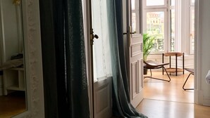 A room with a large window, a wooden floor, and a chair near the window. - Very central apartment in Bilbao a few meters from Gran Vía,  E-BI-752. (Bilbao)