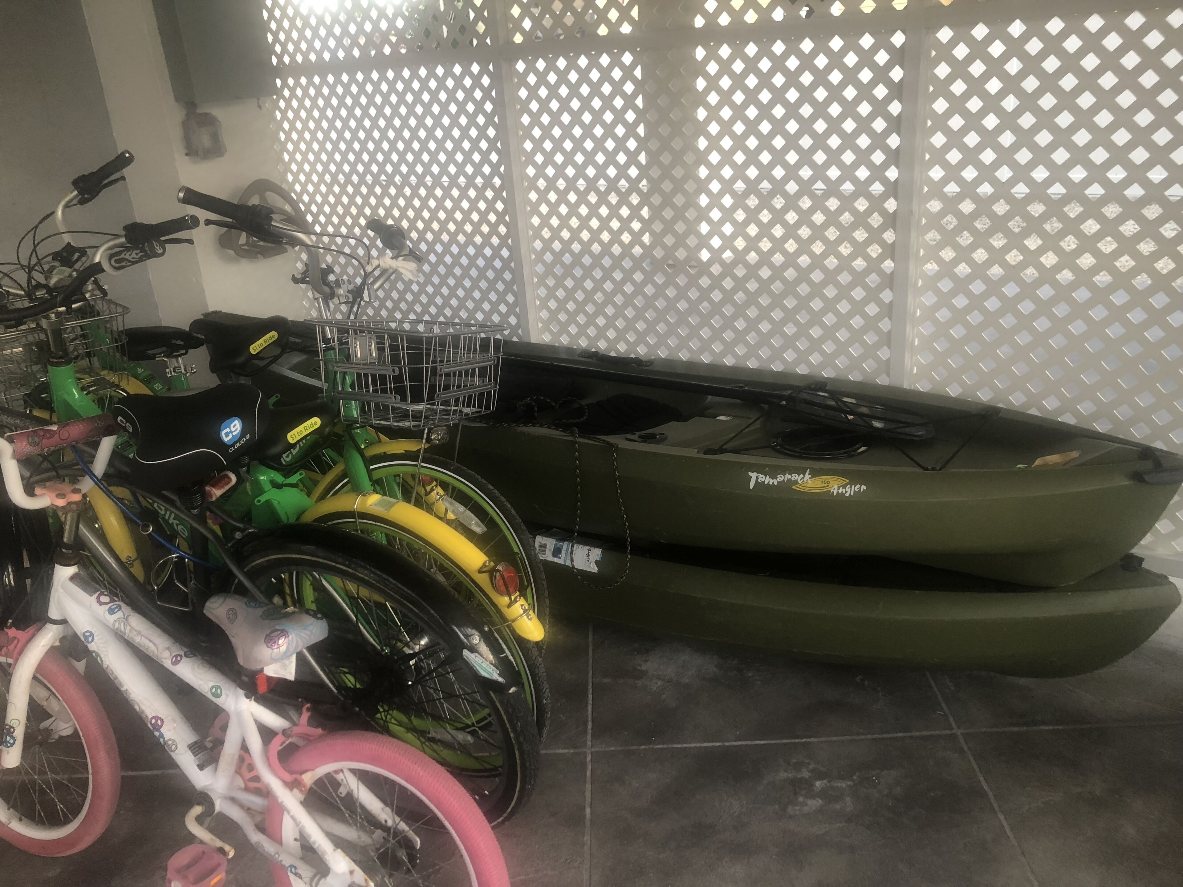 A room with bicycles and a kayak.