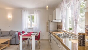 A compact kitchen with a dining area, a built-in oven, and a sink. - Nice home in Liznjan with WiFi (Liznjan)