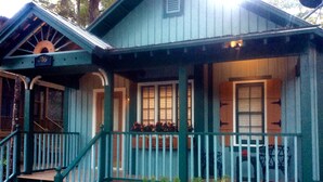 A blue house with a porch, a staircase, and a number '316' sign. - Romantic Spa Experience in Luxurious Creekside Honeymoon Cottage in the Landings (Steinhatchee)