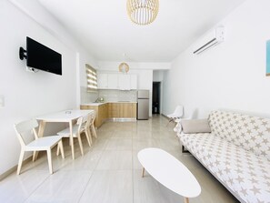 Deluxe Apartment, Garden View | Living area | Flat-screen TV