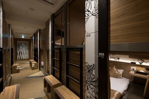 Relax in a stylish room with a large bed, seating area, and bedside table.