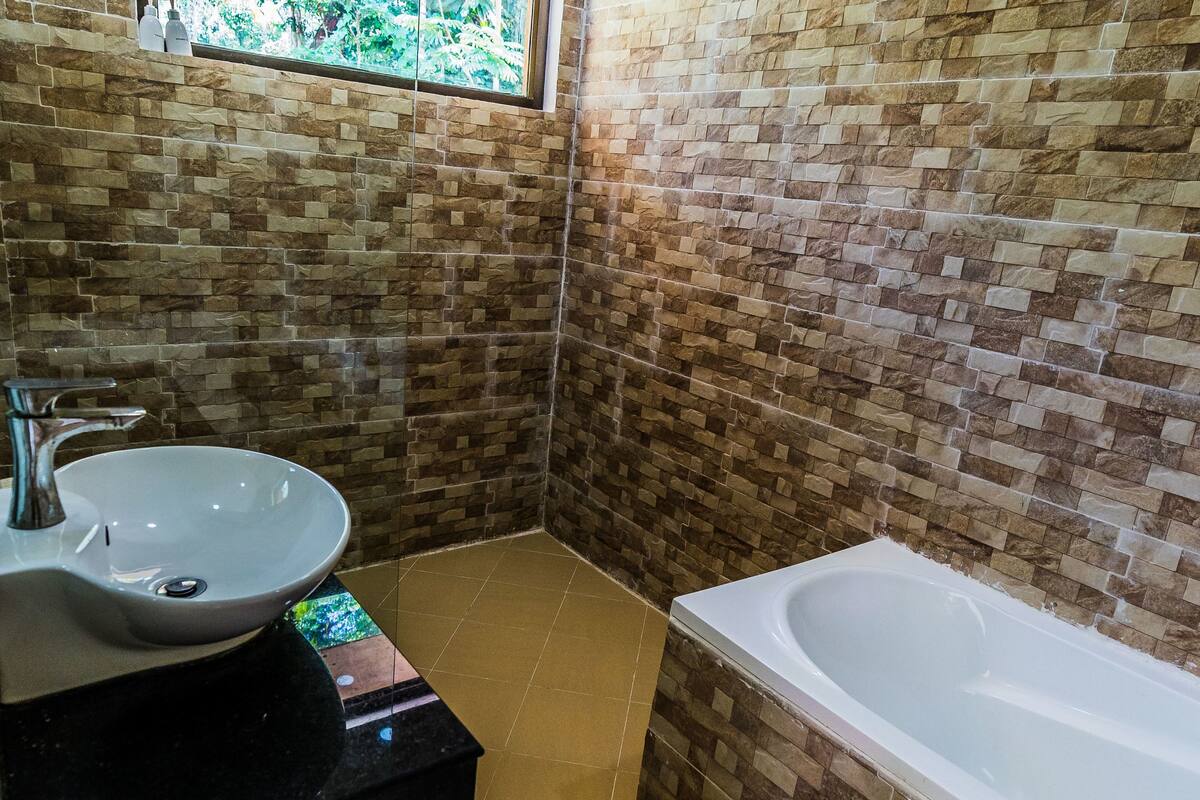 combined shower/bathtub, deep-soaking bathtub, rainfall showerhead