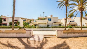 A coastal residential area with modern buildings, palm trees, and a sandy beach. - 3 bedroom nice apartment in Cartagena (Cartagena)